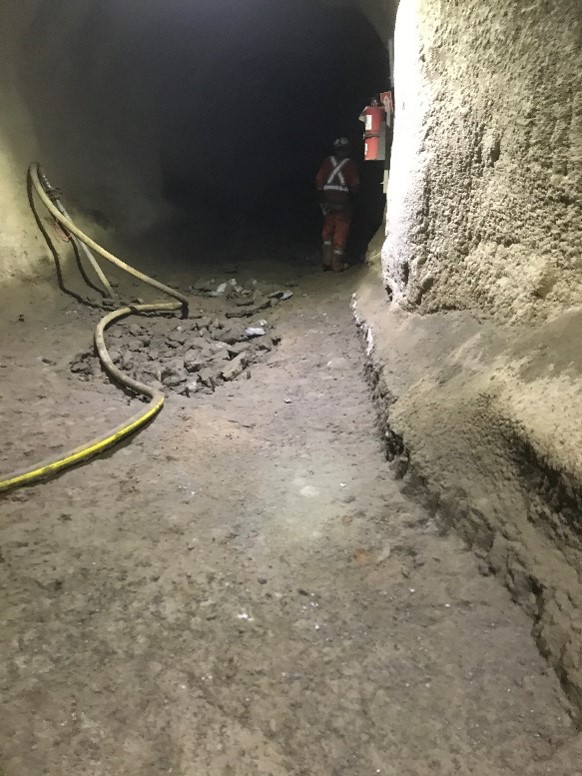 Cleaned and excavated 14” from bottom of an old drift, ballasted and tamped floor base, poured cement floor and installed a block a mortar storage area.
